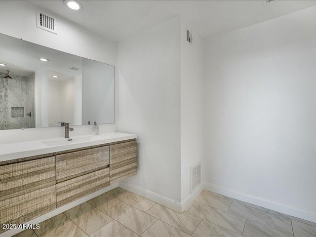 bathroom with vanity and a shower