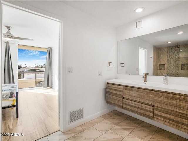 bathroom featuring vanity, ceiling fan, and walk in shower