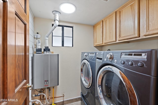 laundry area with separate washer and dryer, tankless water heater, and cabinets