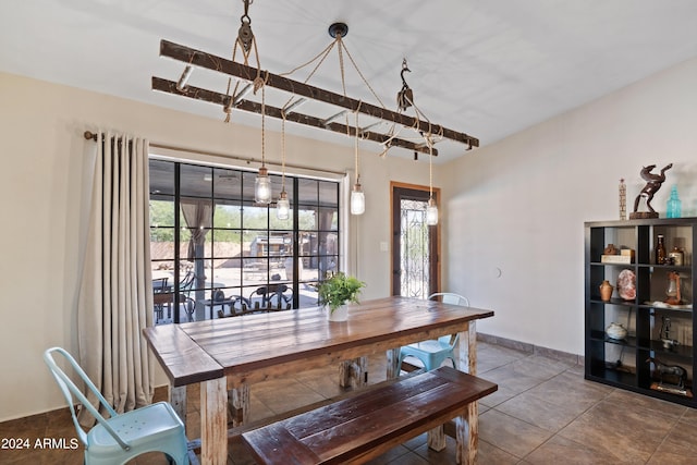 dining room with tile patterned floors and a healthy amount of sunlight