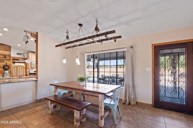 tiled dining area featuring vaulted ceiling