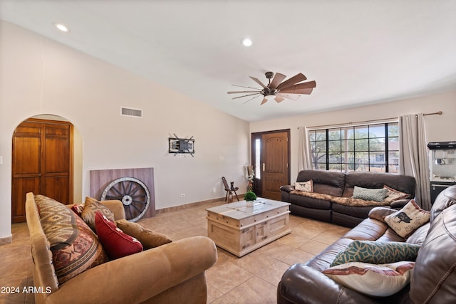 living room featuring lofted ceiling, light tile patterned flooring, and ceiling fan