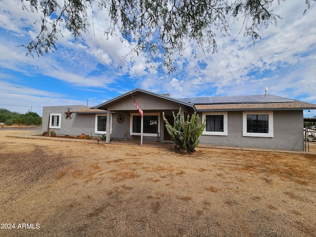 ranch-style house with solar panels