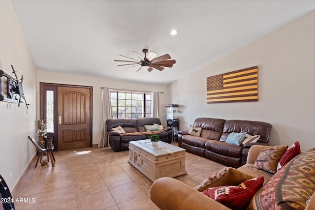 living room featuring vaulted ceiling, ceiling fan, and light tile patterned flooring