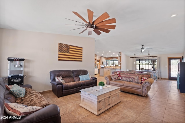 tiled living room with ceiling fan and vaulted ceiling