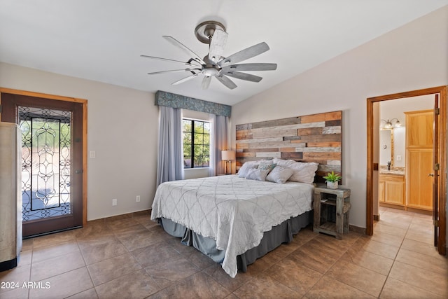 tiled bedroom featuring access to exterior, lofted ceiling, ceiling fan, ensuite bathroom, and sink