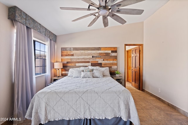 tiled bedroom featuring lofted ceiling and ceiling fan