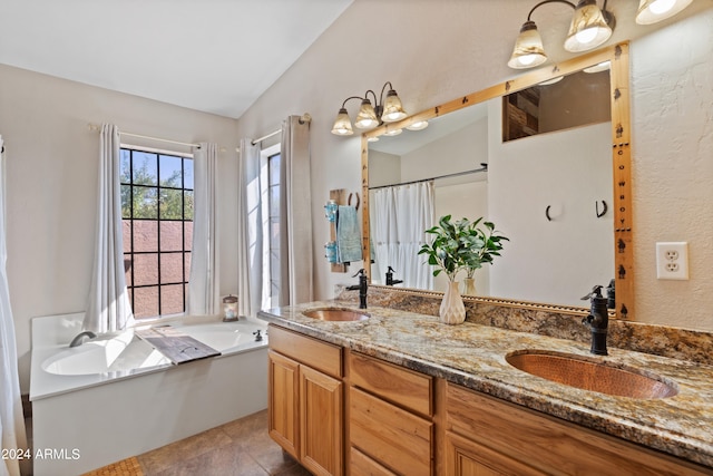 bathroom featuring vanity, lofted ceiling, a bathtub, and tile patterned floors