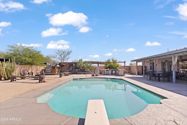 view of pool featuring a patio and a diving board