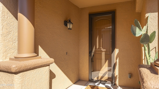 property entrance with stucco siding