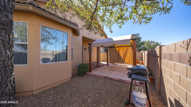 exterior space featuring grilling area and a fenced backyard