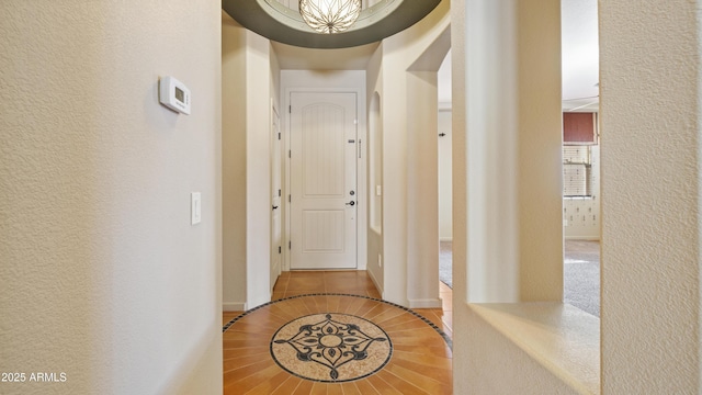 corridor featuring a textured wall and tile patterned flooring