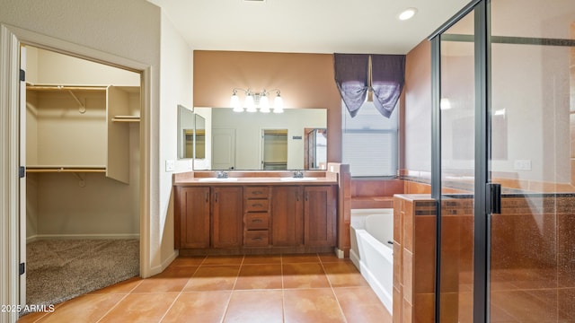 bathroom featuring a stall shower, a garden tub, and a sink