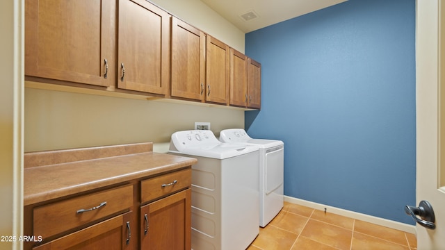 laundry room with cabinet space, visible vents, baseboards, washing machine and dryer, and light tile patterned flooring