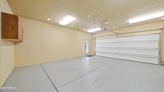 garage featuring recessed lighting and a garage door opener