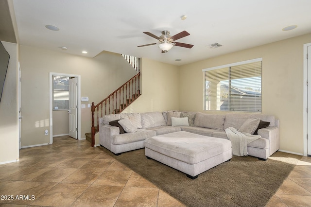 living room with a healthy amount of sunlight and ceiling fan