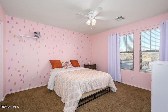 bedroom with ceiling fan and dark carpet