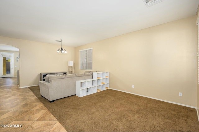 living room featuring carpet and a notable chandelier