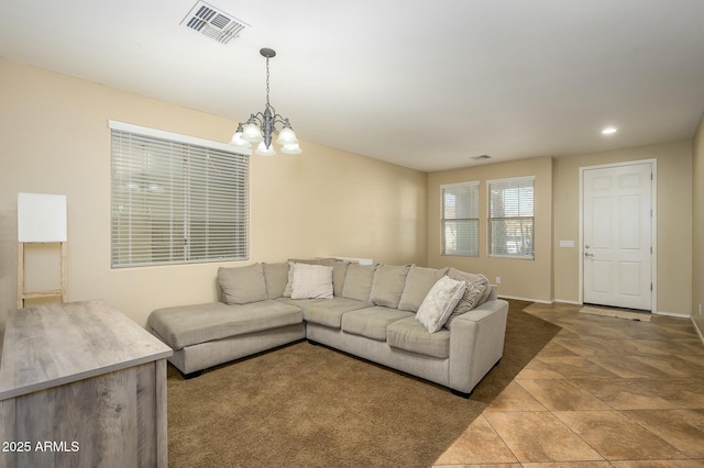 tiled living room featuring an inviting chandelier