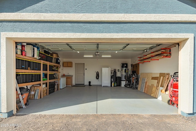 garage with fridge and a garage door opener