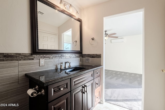 bathroom featuring tile walls, vanity, and ceiling fan