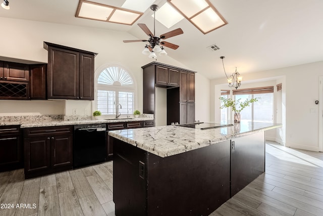 kitchen with a wealth of natural light, black appliances, light hardwood / wood-style floors, and lofted ceiling