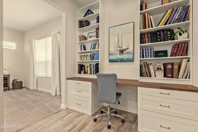 10447 W Salter Dr, Peoria, AZ 85382 - office featuring built in desk, baseboards, and light wood finished floors