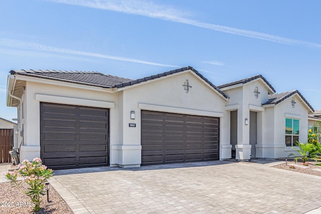 10447 W Salter Dr, Peoria, AZ 85382 - view of front of house with an attached garage, decorative driveway, a tiled roof, and stucco siding