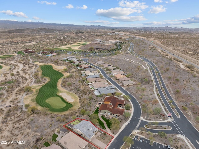 birds eye view of property with golf course view and a mountain view