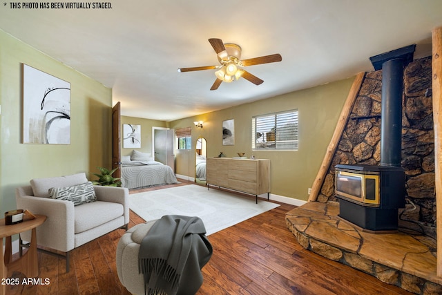 103 E Glade Ln, Payson, AZ 85541 - bedroom featuring hardwood / wood-style floors, a wood stove, and a ceiling fan