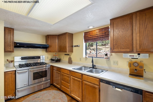 103 E Glade Ln, Payson, AZ 85541 - kitchen featuring stainless steel appliances, exhaust hood, light countertops, brown cabinets, and a textured ceiling