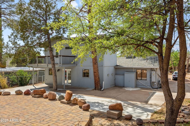103 E Glade Ln, Payson, AZ 85541 - back of house featuring french doors, a balcony, a patio, and roof with shingles