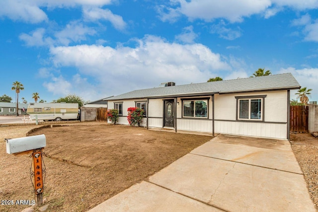 ranch-style house with fence