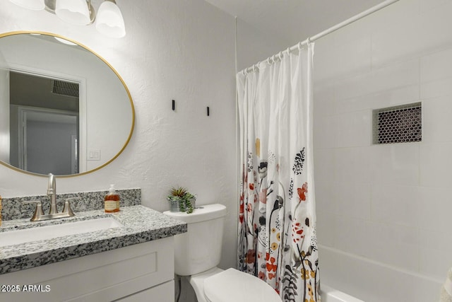 bathroom featuring toilet, shower / bathtub combination with curtain, vanity, and a textured wall