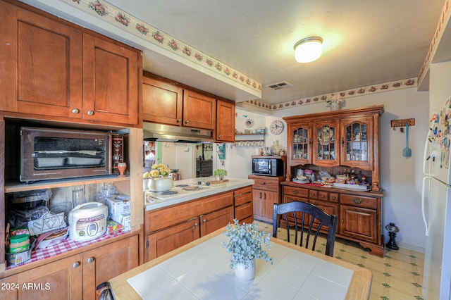 kitchen featuring white gas cooktop and tile counters