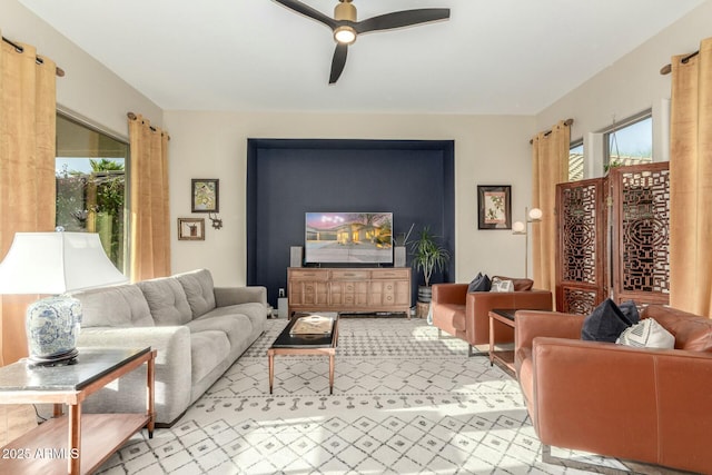 living room featuring a healthy amount of sunlight and ceiling fan