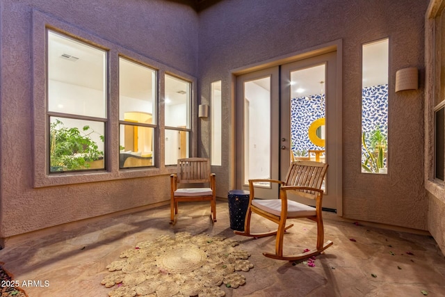 living area with visible vents and french doors