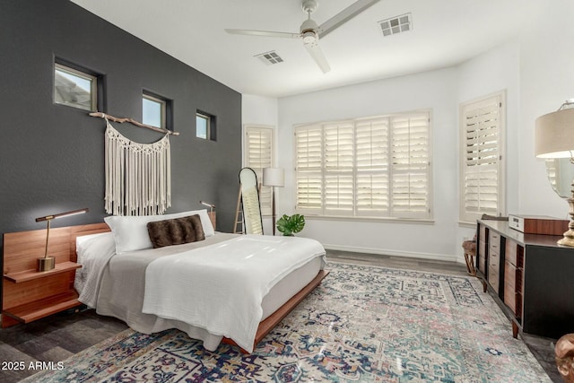 bedroom with visible vents, ceiling fan, baseboards, and wood finished floors