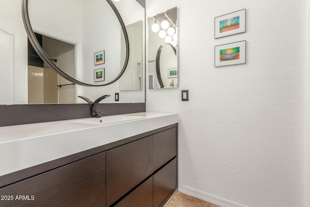 bathroom featuring vanity and baseboards