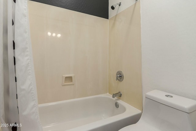 bathroom featuring toilet and shower / tub combo with curtain