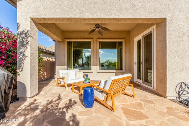 view of patio / terrace featuring fence, an outdoor hangout area, and a ceiling fan