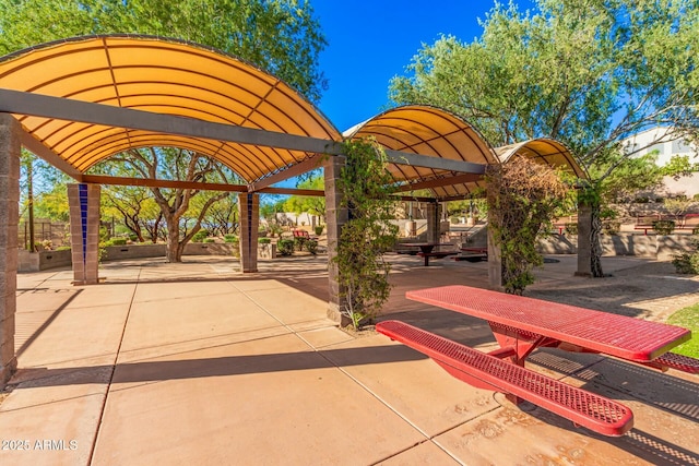 view of community featuring a patio area and a pergola