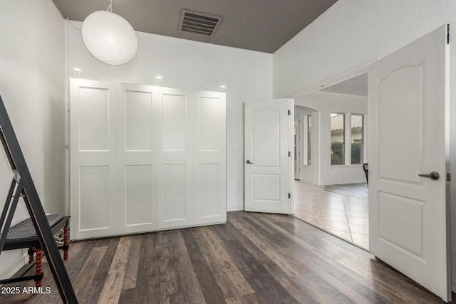 interior space featuring dark wood-type flooring and visible vents