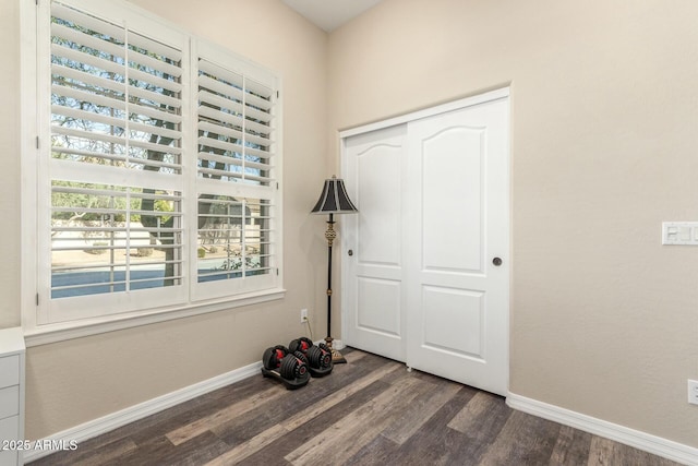 interior space featuring dark wood-style floors and baseboards