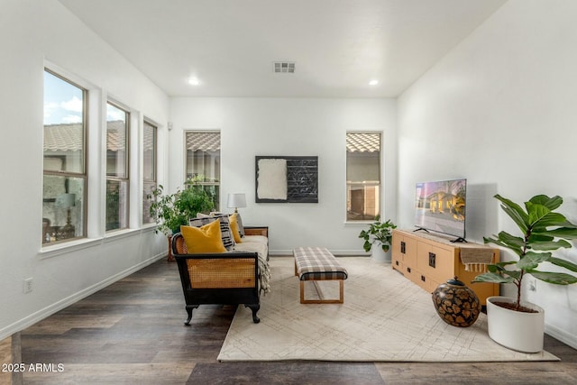 sitting room with baseboards, visible vents, wood finished floors, and recessed lighting