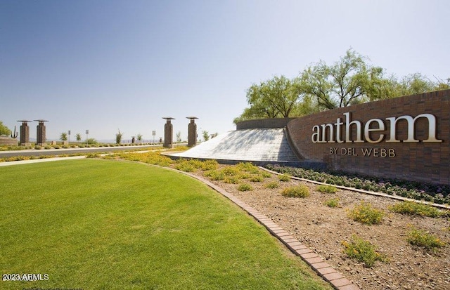 community sign featuring a lawn