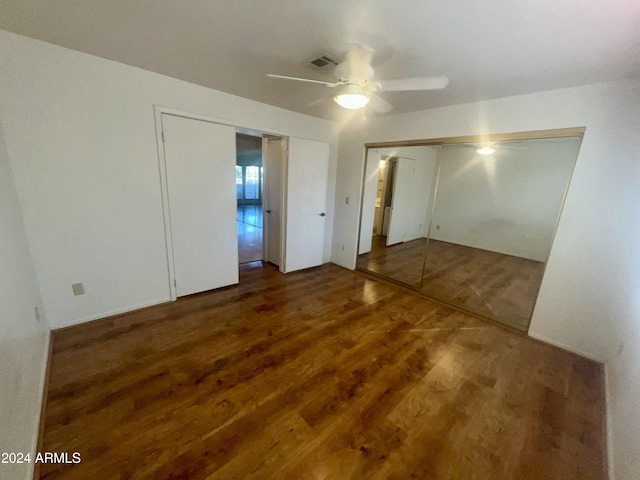 unfurnished bedroom featuring ceiling fan, wood finished floors, and visible vents