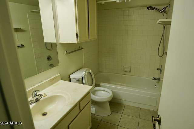 full bathroom with tile patterned flooring, vanity, tiled shower / bath combo, and toilet