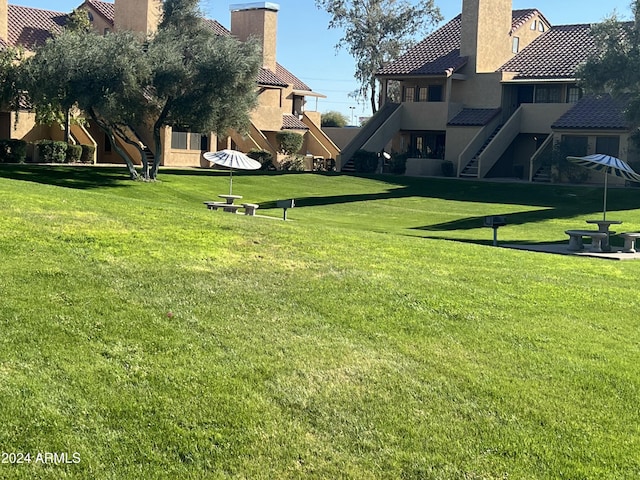 view of community featuring stairs and a lawn