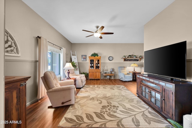 living room featuring wood-type flooring and ceiling fan